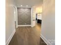 Modern entry hall showcasing a geometric accent wall and hardwood floors at 444 19Th Avenue Nw Cir, Hickory, NC 28601