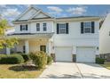 Two story house with white siding, black shutters, and a two car garage at 9904 Rocky Ford Club Rd, Charlotte, NC 28269