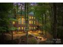 Landscaped backyard with firepit and deck, offering serene outdoor living at 10250 Barringer Ct, Mount Pleasant, NC 28124