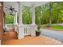 Spacious front porch with white columns and wood flooring at 10250 Barringer Ct, Mount Pleasant, NC 28124