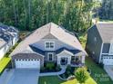 Two-story house situated on a tree-lined lot with a two-car garage at 2716 Manor Stone Way, Indian Trail, NC 28079