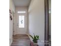 Light and airy entryway with wood-look floors and glass-paned door at 13111 Cottage Crest Ln, Charlotte, NC 28273
