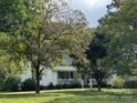 White house with a front porch and landscaping at 24502 St Martin Rd # 37-4184-90, Albemarle, NC 28001