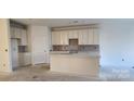 Bright kitchen with white cabinets and an island at 147 Ella Claire Dr # 005, York, SC 29745