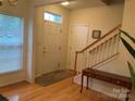 Bright entryway with hardwood floors, stairs, and coat rack at 4016 Holly Villa Cir, Indian Trail, NC 28079