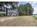 Blue house with a red brick foundation, set back from the road at 12137 Renee Ford Rd, Stanfield, NC 28163