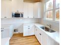 Modern kitchen featuring white cabinets, quartz countertops, and stainless steel appliances at 515 Tates Trl # 39, Cramerton, NC 28032