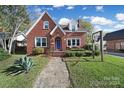 Brick house with a charming front porch and brick walkway at 109 N York St, Lancaster, SC 29720