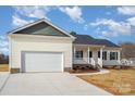 New home with a white exterior, gray roof, and a two-car garage at 2055 Puetts Chapel Rd # 5, Bessemer City, NC 28016