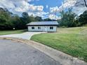 Newly built light gray house with dark gray metal roof and a paved driveway at 901 Linney Ln, Shelby, NC 28152