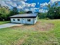 Newly constructed single-story home with a metal roof and grassy yard at 901 Linney Ln, Shelby, NC 28152