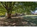 Ranch home with mature tree, driveway, and side yard at 205 Windsor Dr, Salisbury, NC 28144