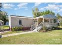 Mobile home with covered porch and landscaping at 1036 Lakeland Ave, Lincolnton, NC 28092