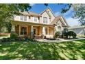 Two story home with landscaping, large front porch and brick accents at 1321 Linden Glen Dr, Matthews, NC 28104