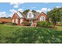 Brick home with landscaped yard at 2488 Birdie Ne Ln, Conover, NC 28613