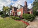 Brick house with a charming front porch and landscaped yard at 109 N York St, Lancaster, SC 29720