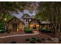 Evening view of a charming two-story home with stone accents at 9716 Sweetleaf Pl, Charlotte, NC 28278