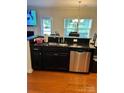 Kitchen island with granite countertop and sink at 7308 Gallery Pointe Ln, Charlotte, NC 28269