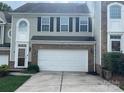 Two-story townhome with a white garage door at 7308 Gallery Pointe Ln, Charlotte, NC 28269