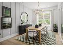 Bright dining room with a large table, chandelier, and green rug at 5313 Mint Harbor Way # 0312, Charlotte, NC 28269