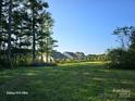 Vacant lot with distant houses and green space at 1176 Shearers Rd, Mooresville, NC 28115