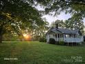 Charming ranch home exterior with large yard at sunset at 1176 Shearers Rd, Mooresville, NC 28115