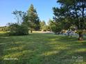 Large vacant lot with road access and mature trees at 1176 Shearers Rd, Mooresville, NC 28115