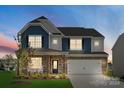 Two-story house with stone and blue siding, rocking chairs on porch, and a two-car garage at 121 Doncaster Dr, Mooresville, NC 28115