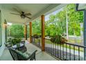 Covered front porch with seating area and wooded views at 540 Kenway Loop, Mooresville, NC 28117