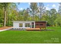 Modern house exterior with wood and white siding, and a deck at 6548 Emerald Isle Dr, Sherrills Ford, NC 28673