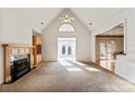 Spacious living room with fireplace and sunroom access at 108 Cottonwood Dr, Mount Holly, NC 28120