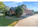 Brick home with attached garage and manicured lawn at 108 Cottonwood Dr, Mount Holly, NC 28120