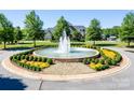Bailey's Glen community entrance with a circular fountain and landscaping at 12821 Mayes Rd, Huntersville, NC 28078