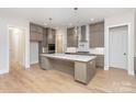 Modern kitchen with gray cabinets, quartz countertops, and island at 1336 Sage Pine Cir # 21, Clover, SC 29710