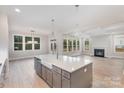 Open concept kitchen with large island, stainless steel appliances, and hardwood floors at 1336 Sage Pine Cir # 21, Clover, SC 29710