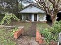 Small cottage with a front porch and overgrown yard at 213 Belt Dr, Lowell, NC 28056