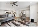 Spacious living room with gray sectional sofa, glass coffee table, and hardwood floors at 1332 Lena St, Monroe, NC 28112