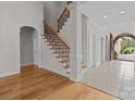 Elegant entryway with hardwood floors, a grand staircase, and arched doorways at 4532 Lanstone Sw Ct, Concord, NC 28027