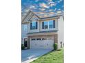 Two-story townhome with gray siding, stone accents, and a two-car garage at 145 Beacon Dr # F, Mooresville, NC 28117