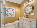 Elegant bathroom with a granite vanity, a walk-in shower, and stained glass window at 316 W Kingston Ave, Charlotte, NC 28203