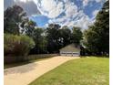 Triple-car garage with a long driveway and fenced yard at 142 Scotland Dr, Mooresville, NC 28115