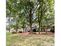 Two story house nestled among lush trees and landscaping at 142 Scotland Dr, Mooresville, NC 28115
