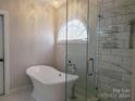 Elegant bathroom with a soaking tub and glass shower at 4905 Benthaven Ln # 321, Charlotte, NC 28269