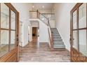 Bright entryway with hardwood floors, staircase, and double doors at 0002 Bolton Rd, Catawba, NC 28609