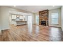 Open floor plan with kitchen island, stone fireplace, and hardwood floors at 0002 Bolton Rd, Catawba, NC 28609