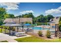 Community pool with gazebo, picnic tables, and lounge chairs at 6132 Heath Ridge Ct, Charlotte, NC 28210