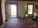 Front entrance with a red door, and a view of the yard beyond at 2981 Old Nc 150 Hwy, Crouse, NC 28033