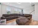 Relaxing living room with large sectional sofa and hardwood floors at 1134 Keydet Dr, Charlotte, NC 28216