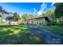 Mid-century modern home with expansive windows at 501 Journey Sw St, Concord, NC 28025
