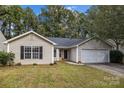 House exterior featuring a tan colored vinyl sided home with a 2-car garage at 2223 Mancke Dr, Rock Hill, SC 29732